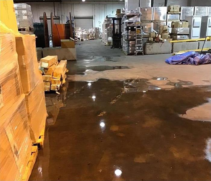 warehouse with pallets and water on the ground