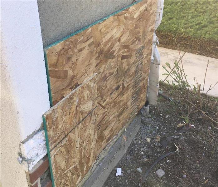 boarded up wall from where a DUI Driver went thru. 